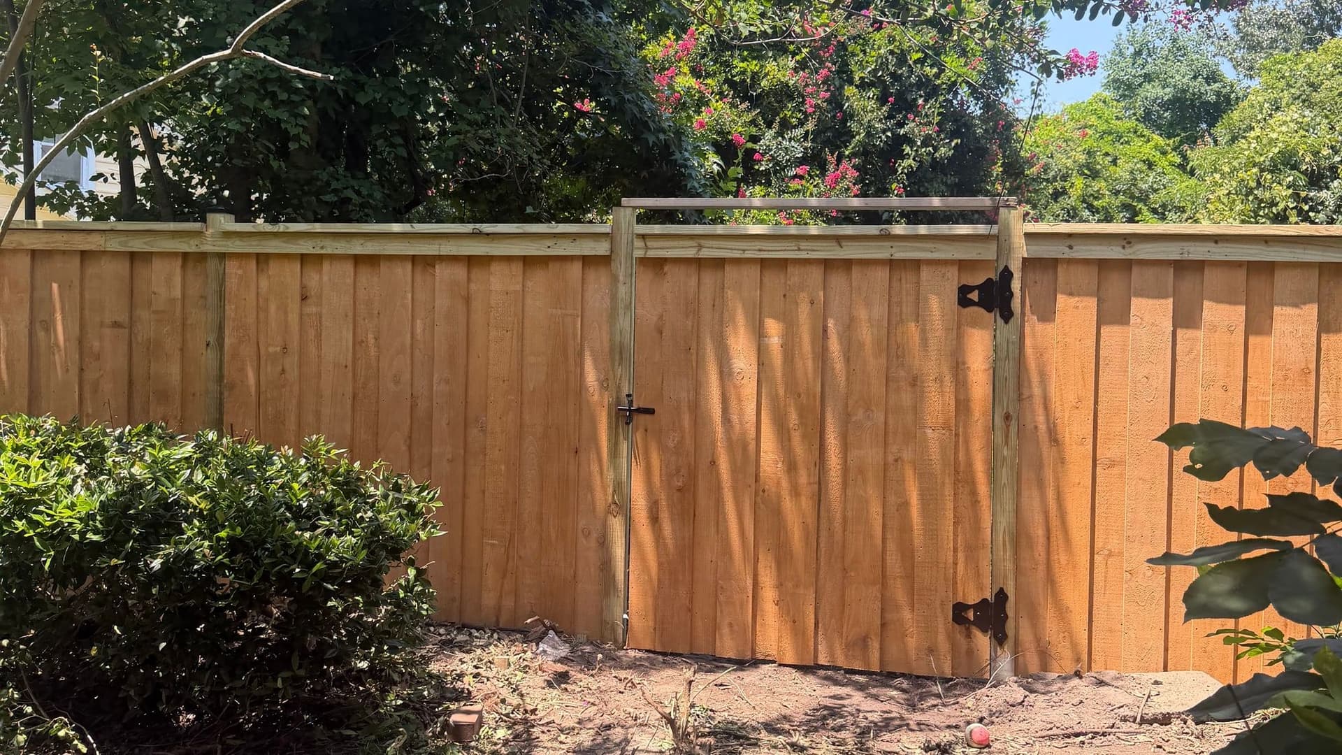 Cedar-toned wood fence and gate built by Walter Handyman LLC