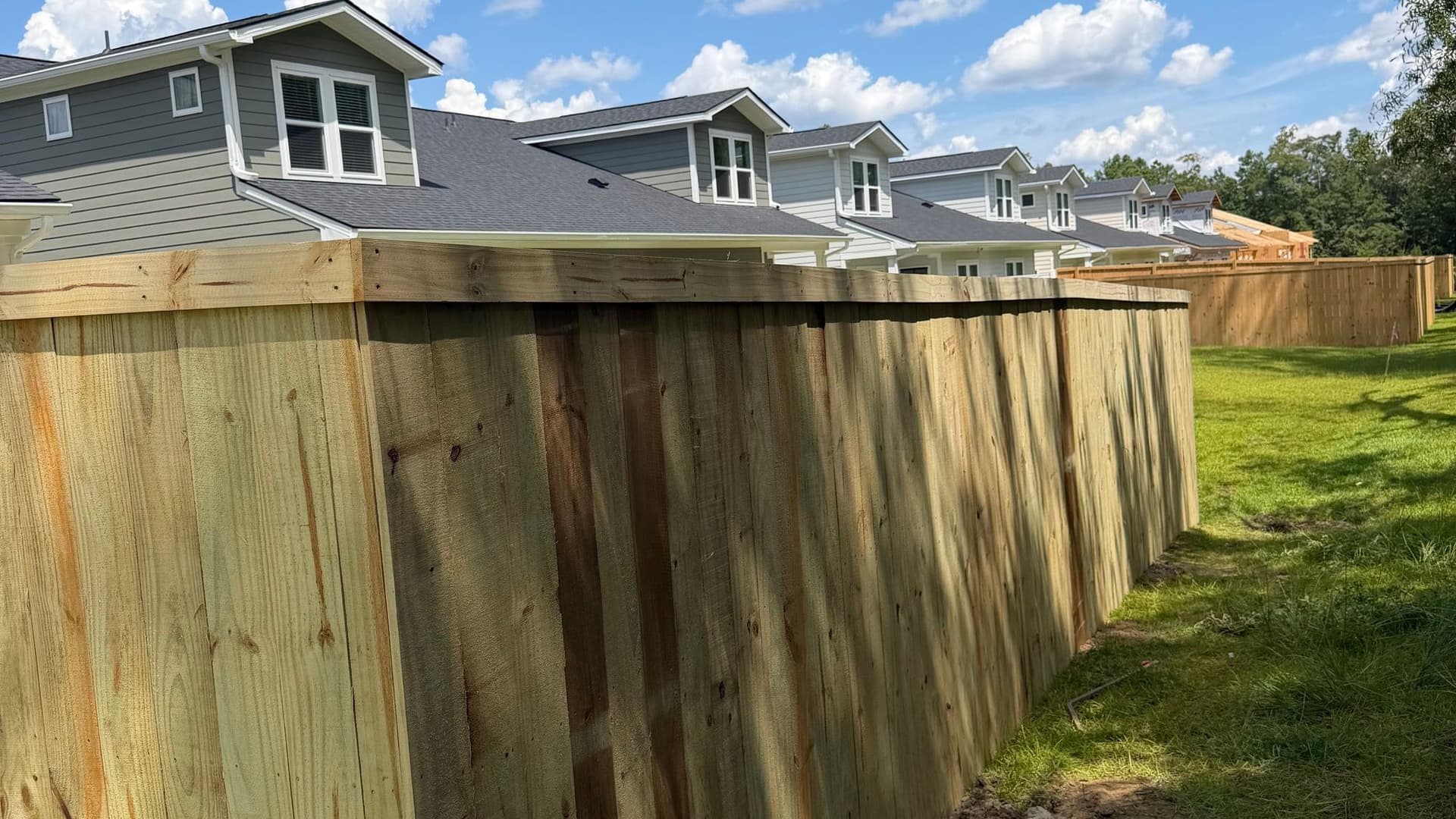 Privacy fence running behind a row of Charleston-area homes